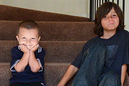 Photo of two boys sitting on stairs. Links to Gifts of Life Insurance
